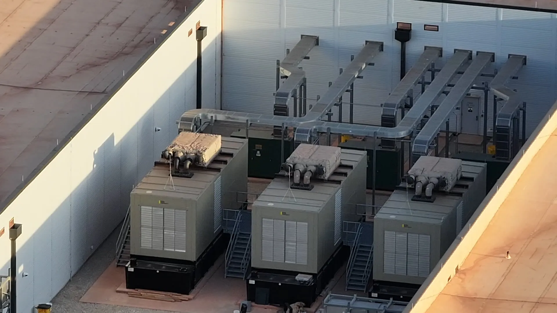 Industrial backup diesel generator and exhaust stack at a data center site