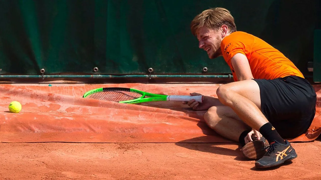 David Goffin on the clay court at Roland Garros after slipping on a folded tarpaulin rain cover in 2017