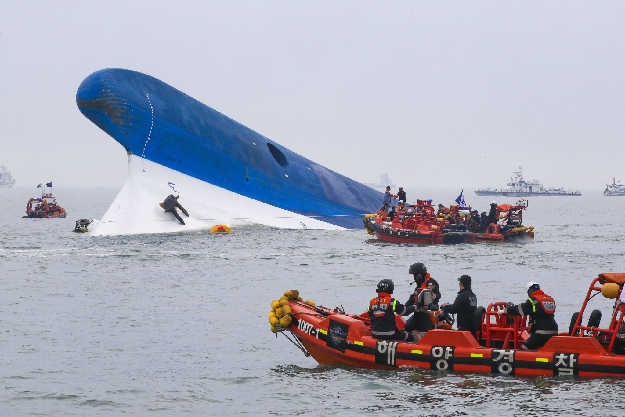 MV Sewol ferry listing heavily in the water with rescue boats nearby