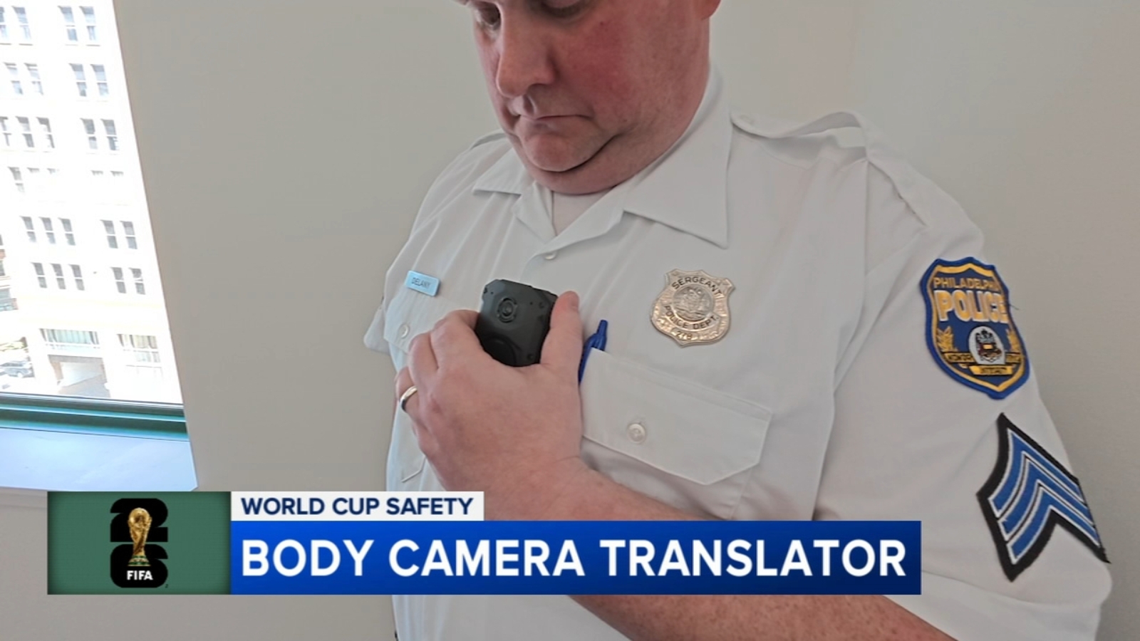 Philadelphia police officer wearing a body-worn camera with real-time AI translation capability near a World Cup event area
