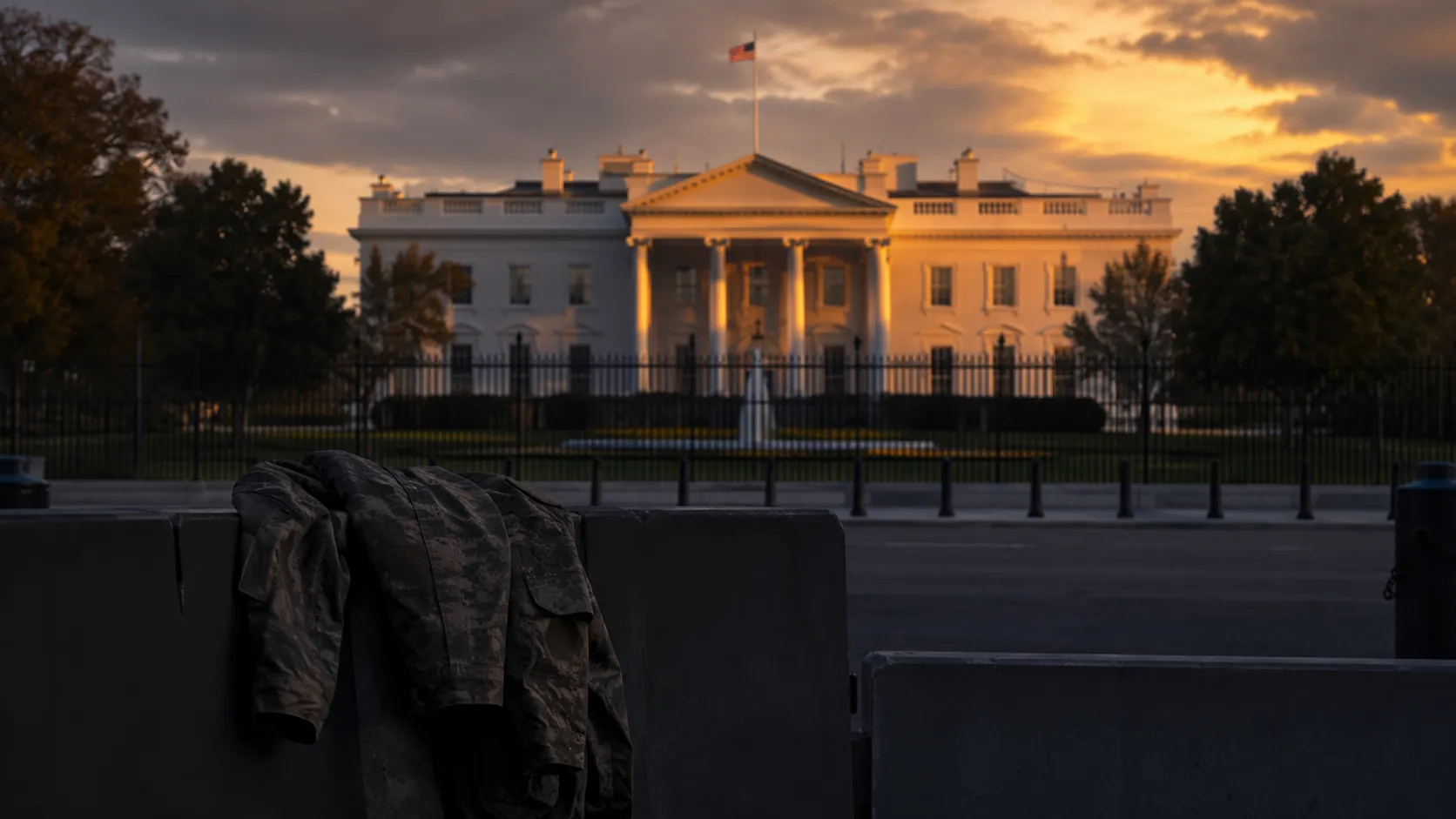 White House security checkpoint at dusk with a military jacket draped over a barricade