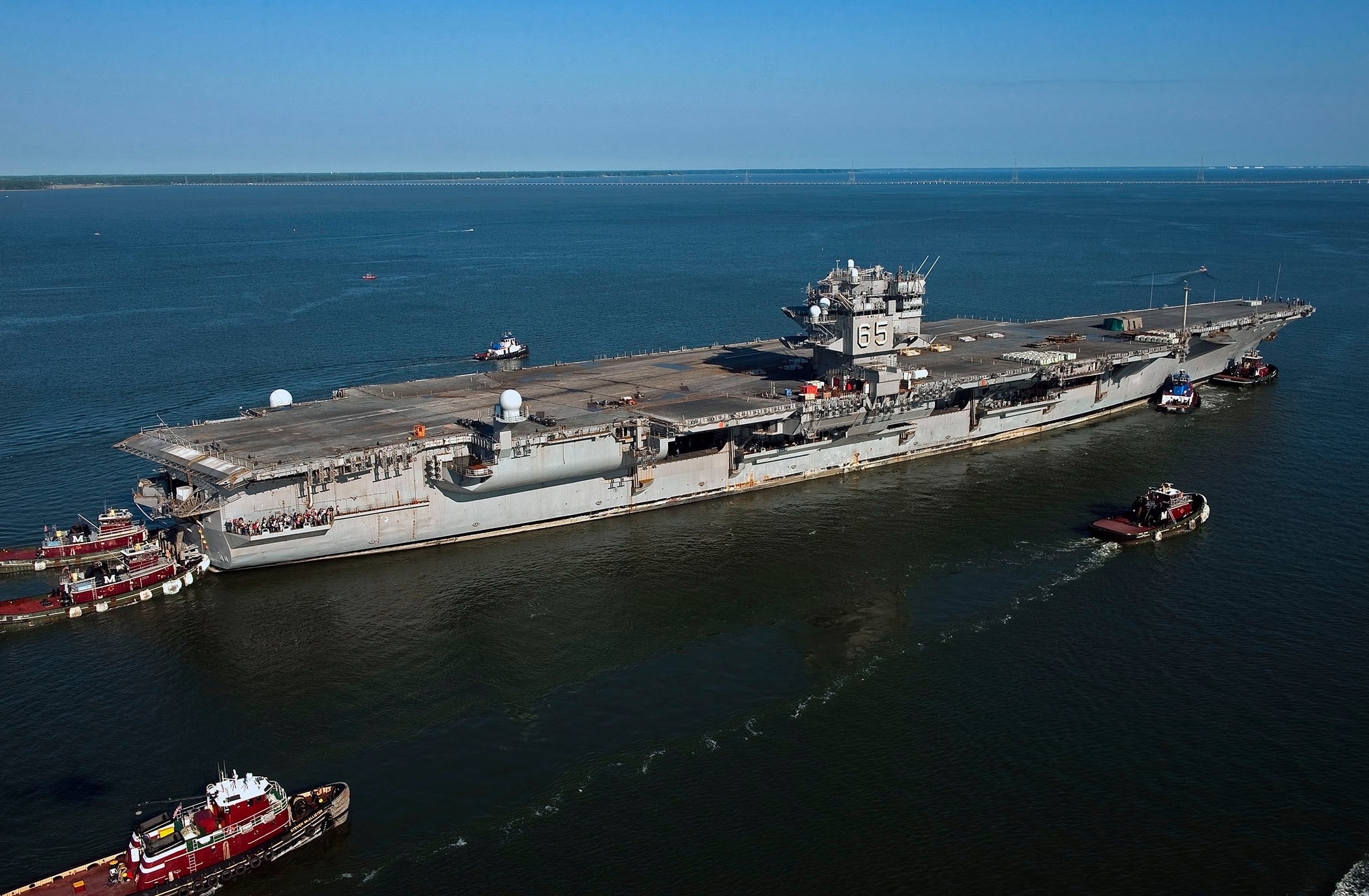Decommissioned USS Enterprise moored at Newport News Shipbuilding with cranes alongside the stripped flight deck