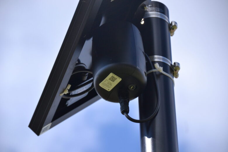 A Flock Safety Raven device mounted on a pole in a residential neighborhood in Jackson, Mississippi
