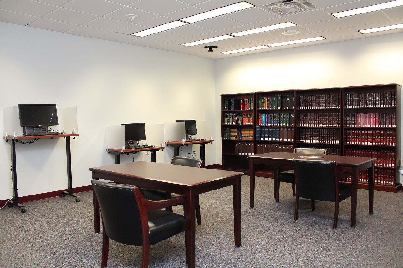 Self-help center inside the John A.H. Murphree Law Library with legal reference shelves, public computers, and research desks