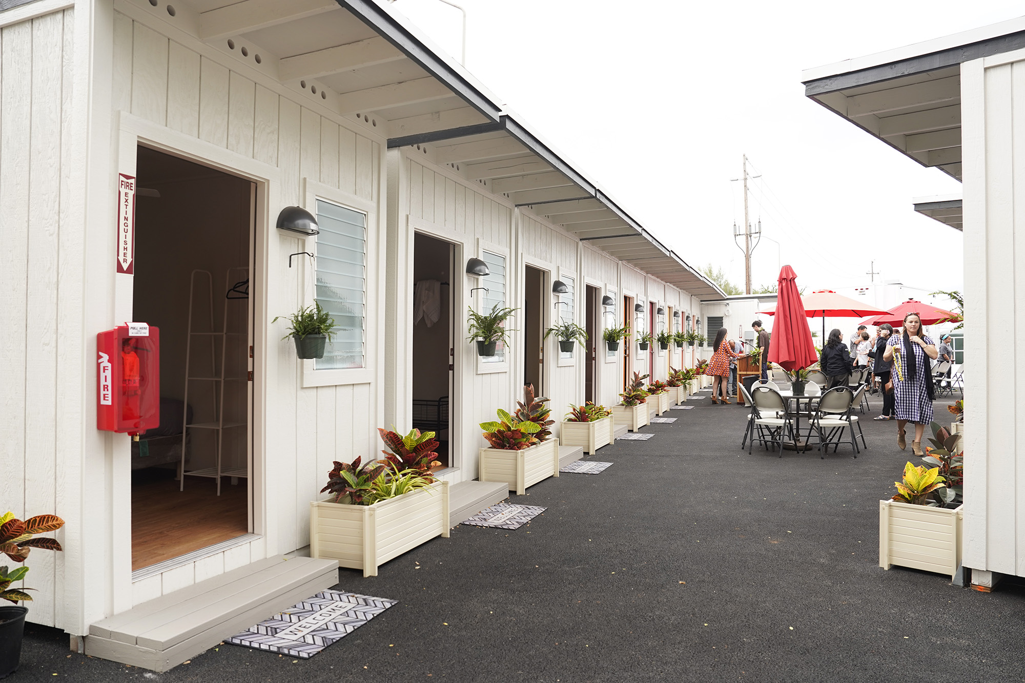 A Kauhale village of compact tiny homes along a tropical pathway