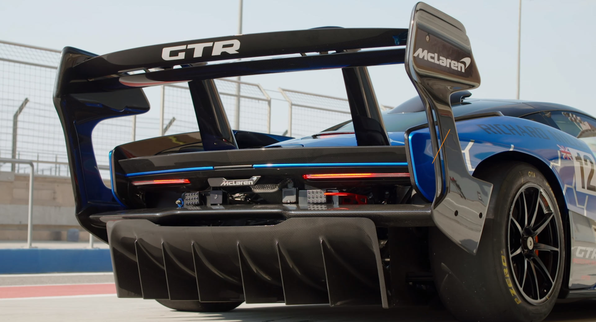McLaren Senna GTR on a racetrack with large rear wing and aggressive diffuser