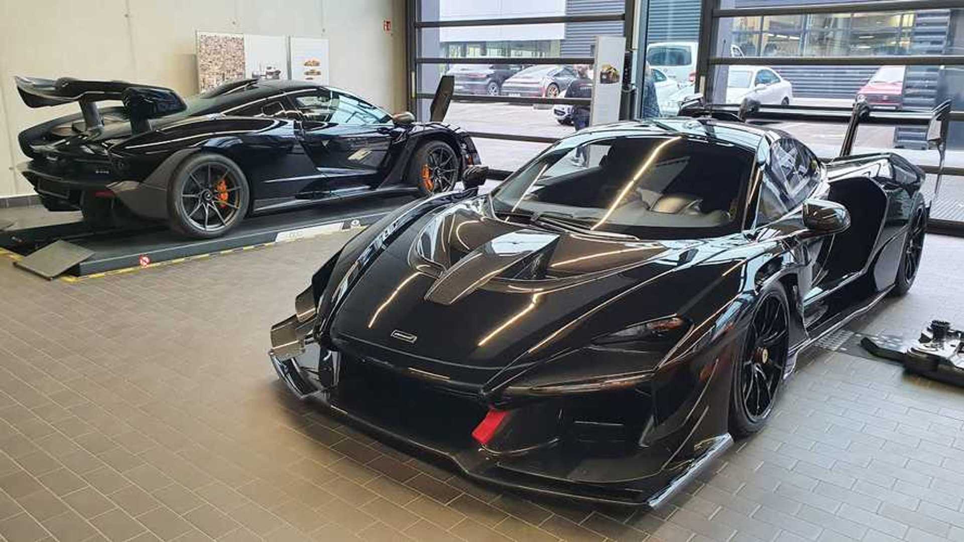 McLaren Senna and Senna GTR parked side by side, showing the road car beside the track-only GTR with larger aero bodywork