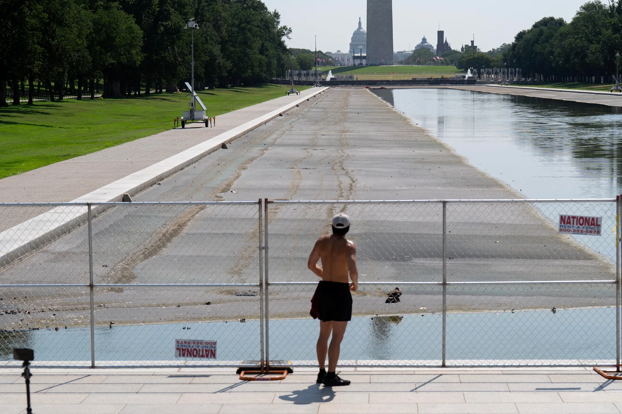 Drained Lincoln Memorial Reflecting Pool with exposed liner and the Washington Monument in the background