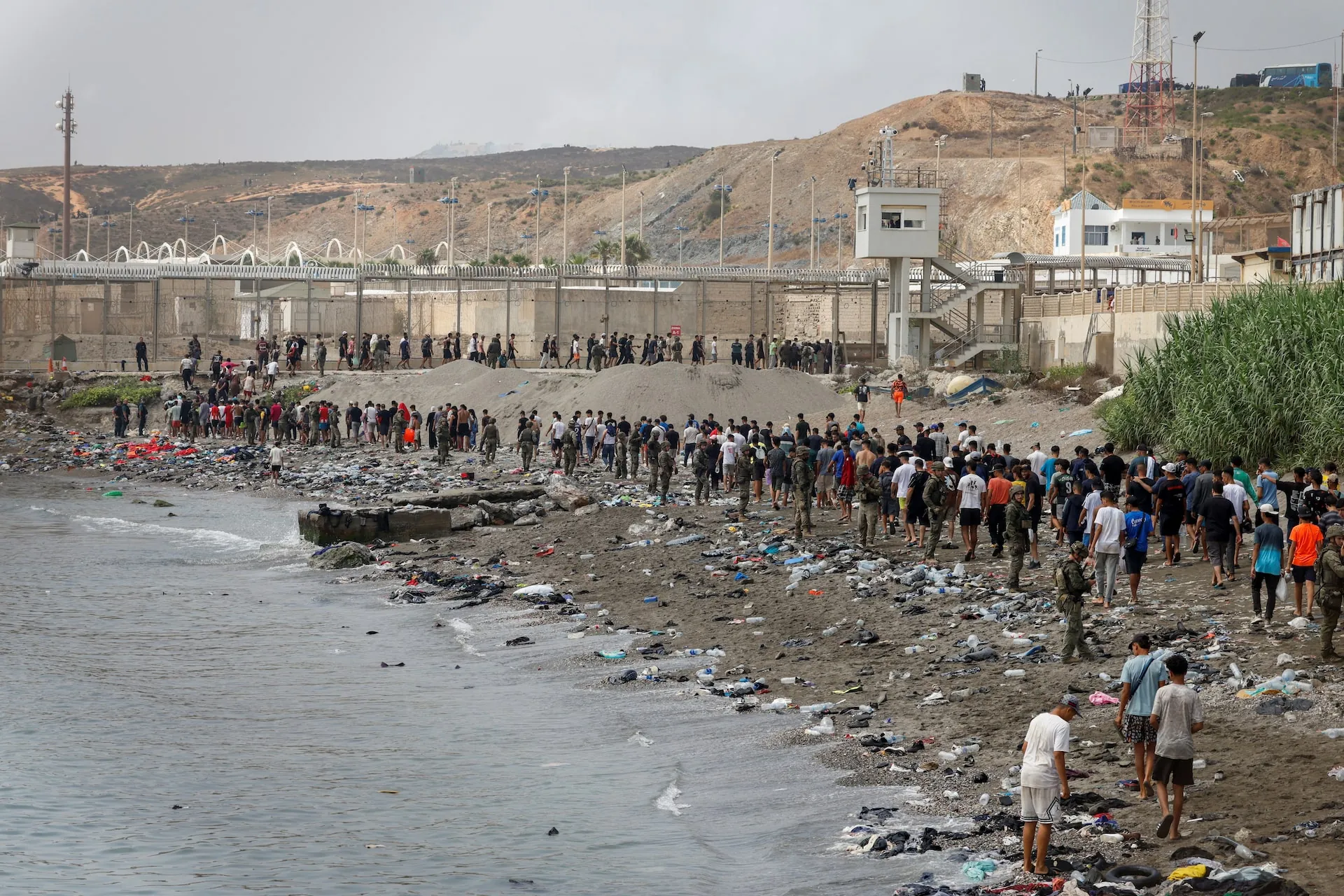 Crowds moving through the border area during the July 2026 Ceuta migrant surge