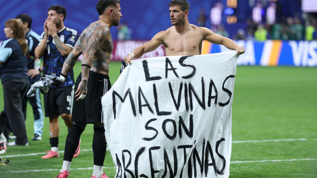 Argentina players holding a Las Malvinas son Argentinas banner after a World Cup semifinal